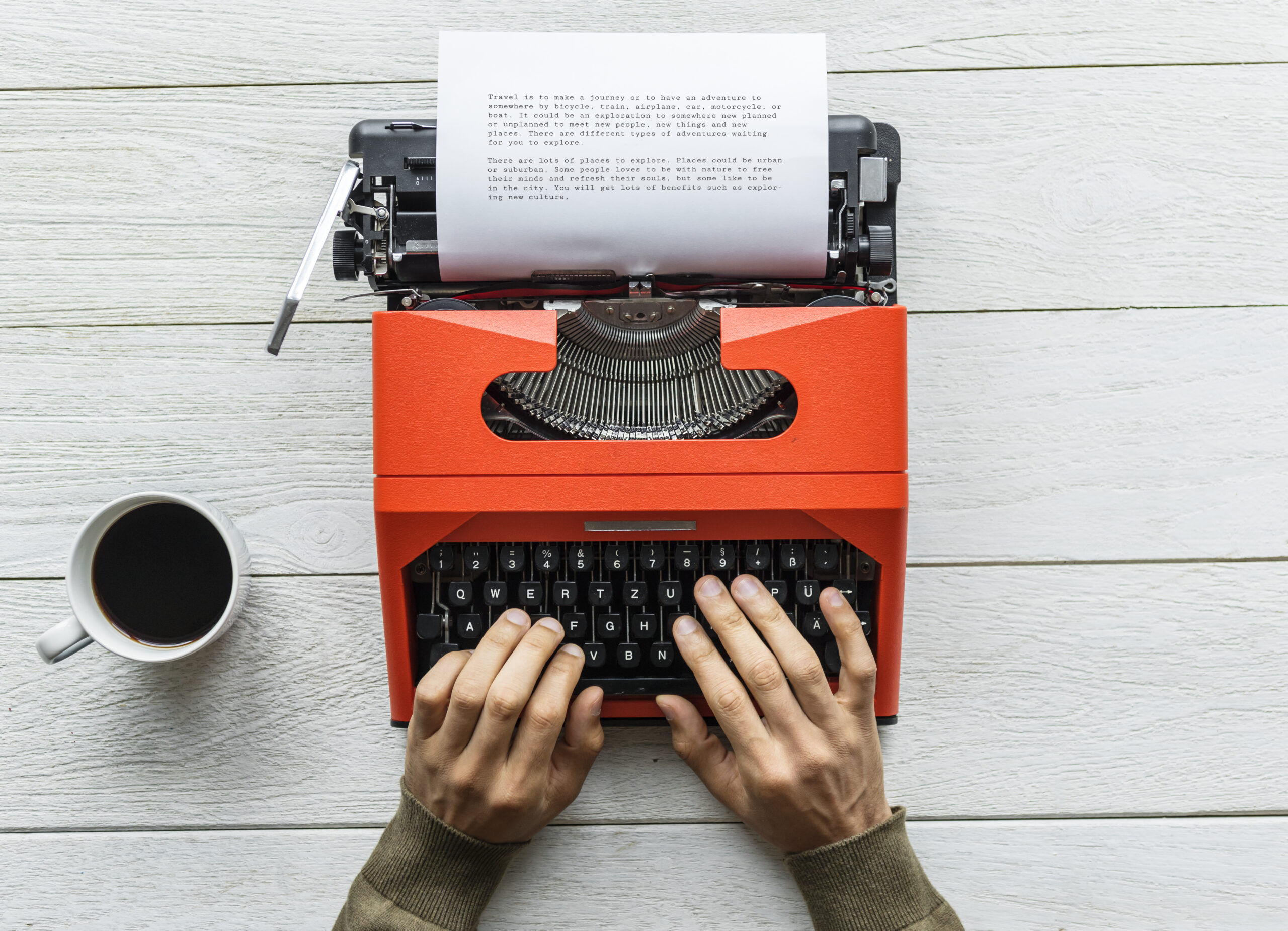 Aerial view of a man typing on a retro typewriter